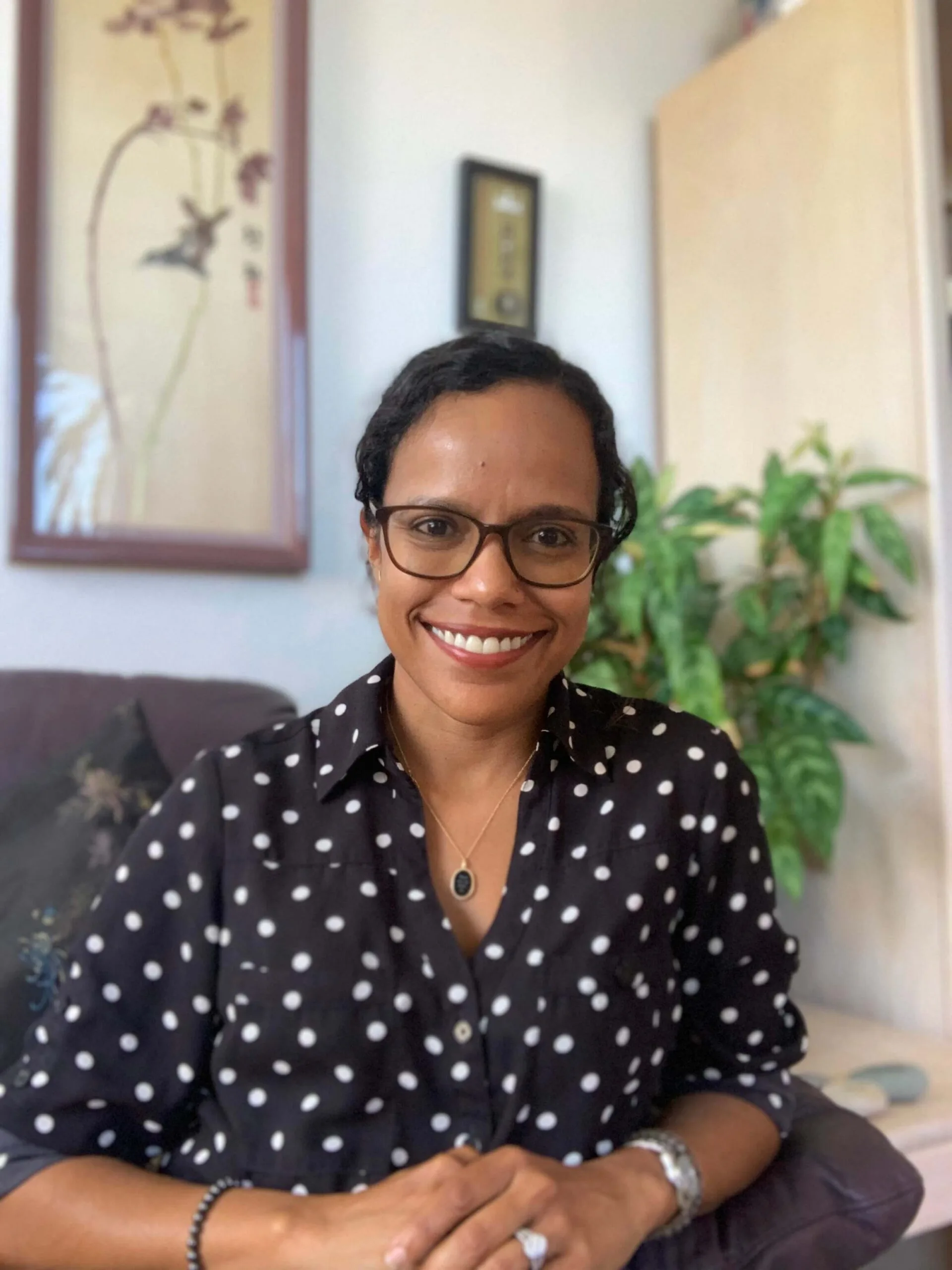 Sheba S. Andrew-Popp, EMDR therapist, smiling in her therapy office